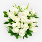 A round bouquet of white roses, tulips, and daisies with green leaves.