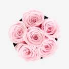 Pink preserved roses in a black box, symbolizing grace and affection.
