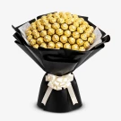 Bouquet of 99 Ferrero Rocher chocolates in gold wrappers, with black and white paper, tied with a white ribbon.