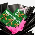 Pepero Almond chocolate sticks in gift wrapping with pink tissue paper and a pink bow.