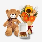 A teddy bear, a bouquet of sunflowers and gerberas, and a tiramisu bento.