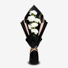 Bouquet of white carnations wrapped in black paper with a twine bow.