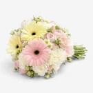 Bouquet with pink and yellow gerbera daisies, white carnations, and pink roses.