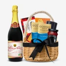 Gift basket with sparkling grape juice, shortbread, cocoa, coffee, and chocolate bars.