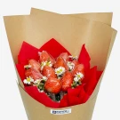 Chocolate-dipped strawberries adorned with daisies, wrapped in red paper and brown kraft paper.
