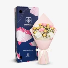 Pink carnations and chocolates in a bouquet with a decorative box.