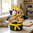 Birthday gift box with stuffed lion and giraffe, chocolates, and "Happy Birthday" topper.