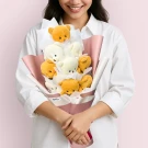 Woman holding a bouquet of white flowers and brown teddy bears, with pink and white wrapping.