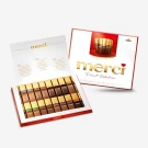 Box of Merci finest selection assorted chocolates, open to reveal rows of individually wrapped chocolate bars.