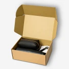 Brown cardboard box containing a black insulated tumbler, brown pouch, and black leather keychain.