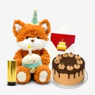Fox plush with birthday hat holds a cupcake next to a chocolate cake and a birthday card.