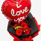 Heart-shaped "I love you" balloon above a bouquet of red roses, carnations, and gerberas.