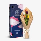 Meadow Melody bouquet with tulips next to its blue floral gift box.