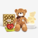 Brown teddy bear with Ferrero Rocher chocolates, a heart pop-up card, and a bear lamp.