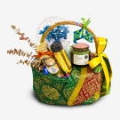 A Hari Raya gift basket with chocolates, candle, and decorative ketupat ornaments.