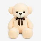 Cream-colored giant teddy bear with a brown bow tie, sitting against a white background.