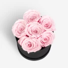 Black box with six soft pink preserved roses, symbolizing grace and affection.