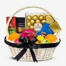 Gift basket with Ferrero Rocher, Godiva chocolate, coffee, tea, and fresh fruit.