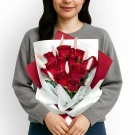 Bouquet of 10 glitter-dusted red roses with bunny tails, held by a person.