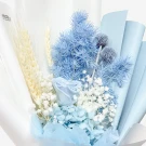 A bouquet of dried light blue flowers, white baby's breath, and wheat stalks.