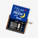 A music box with a blue lid, showing a moon and stars, and the text "I love you to the moon and back."