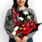 Chocolate and flower bouquet with KitKats, Hershey's, Ferrero Rocher, and white carnations.