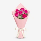 Bouquet of 6 vibrant pink roses and white accent flowers, wrapped in pink paper and tied with a cream ribbon.
