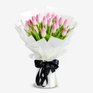 Bouquet of 20 pink tulips wrapped in white paper with a black ribbon.