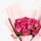Bouquet of 12 pink roses wrapped in pink paper.