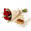 Red rose bouquet and tiramisu cake with "Happy Birthday" topper.