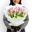 Bouquet of 20 pink tulips, wrapped in white paper with a black ribbon.