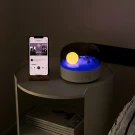 Ocean Dream Speaker Lamp with a phone playing music on a side table.