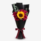 Sunflower and maroon mums in black paper wrap with a dark red ribbon.