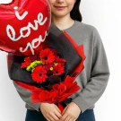 Heart balloon with "I love you" message and red floral bouquet.