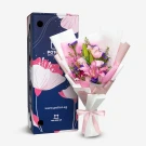 Pink lilies and roses bouquet in white and pink paper, with a blue patterned box from Potico.