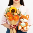 Fox plushie with cupcake and birthday bouquet of sunflowers and orange gerberas.