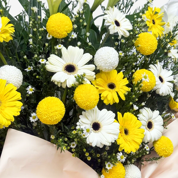 Yellow and white gerbera daisies and yellow ping pong chrysanthemums.
