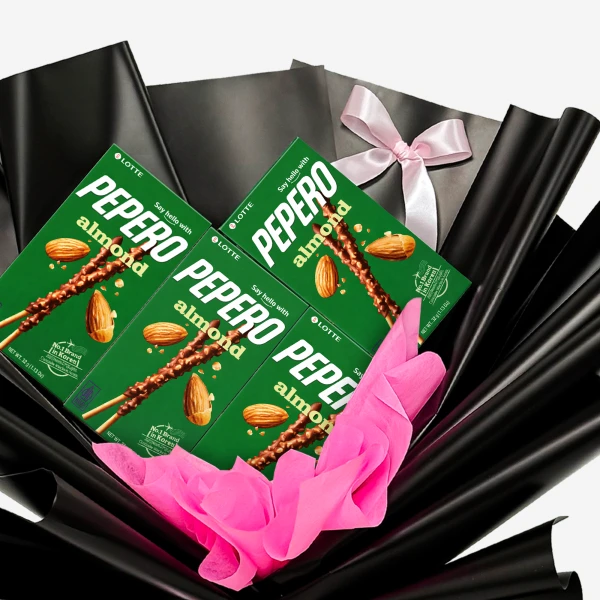 Pepero Almond chocolate sticks in gift wrapping with pink tissue paper and a pink bow.