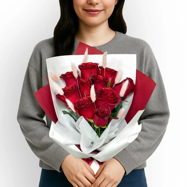 Bouquet of 10 glitter-dusted red roses with bunny tails, held by a person.