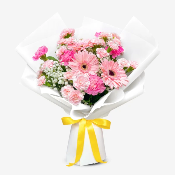 Pink gerberas and carnations in white paper wrap with a yellow ribbon.