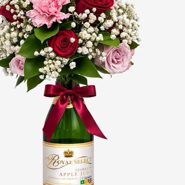 Bouquet of pink and red roses and carnations in a green sparkling apple juice bottle with a red ribbon.