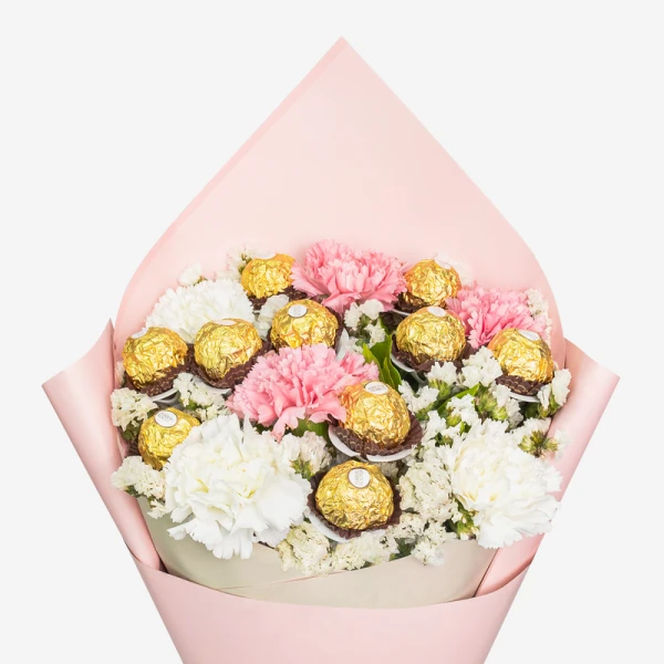 Bouquet with pink and white carnations, baby's breath, and Ferrero Rocher chocolates in pink wrapping.