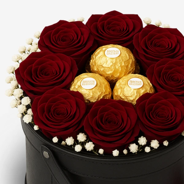 Red roses and Ferrero Rocher chocolates in a black round box.