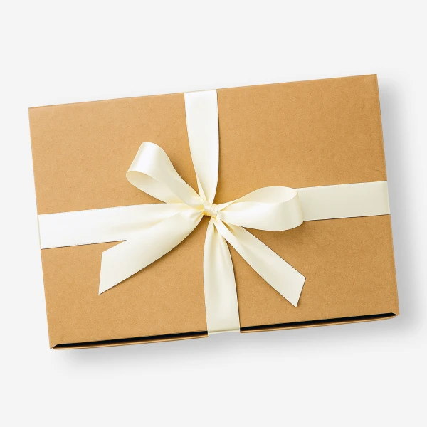 Brown gift box with cream ribbon tied in a bow, on a white background.