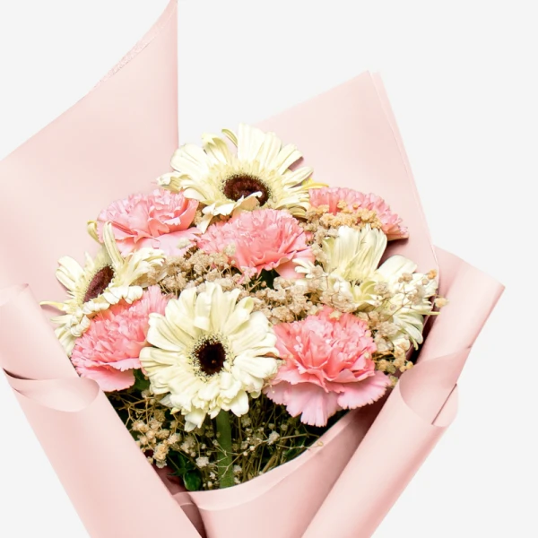 Pink carnations and white gerberas with baby's breath in pink wrapping paper.