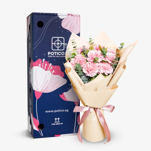 Pink carnation bouquet with eucalyptus, next to a navy blue box with pink floral design.