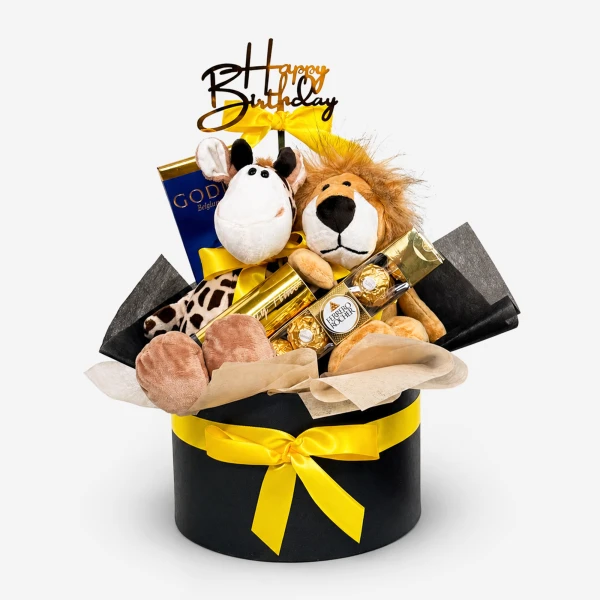 Birthday gift box with stuffed lion and giraffe, chocolates, and 'Happy Birthday' topper.