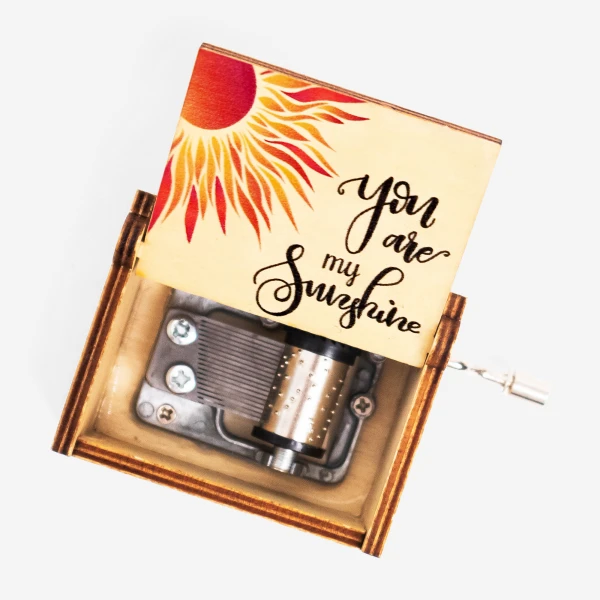Wooden music box with a sun design and "You are my sunshine" handwritten text.