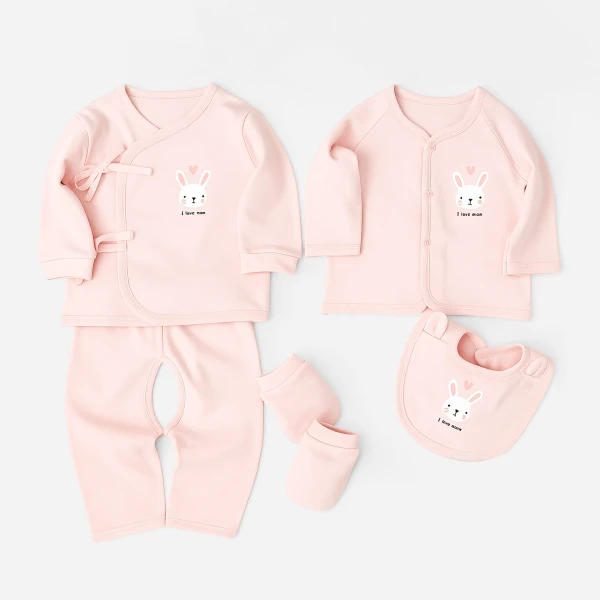 Pink baby girl clothing set with bunny print, including top, pants, bib, and mittens.