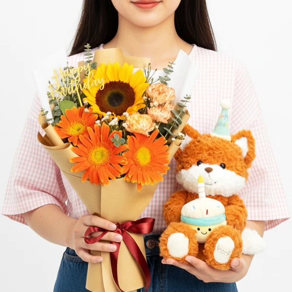 Fox plushie with cupcake and birthday bouquet of sunflowers and orange gerberas.
